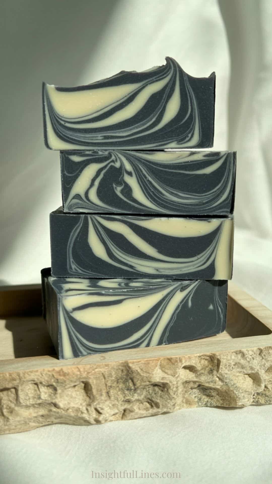 Handcrafted charcoal melt and pour soap bars with dramatic black and white swirl patterns