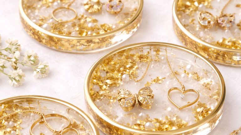 gold leaf resin trinket dish displaying jewelry inside